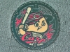 Manhole cover with the mascot of the Hiroshima Tōyō Carp professional paseball team