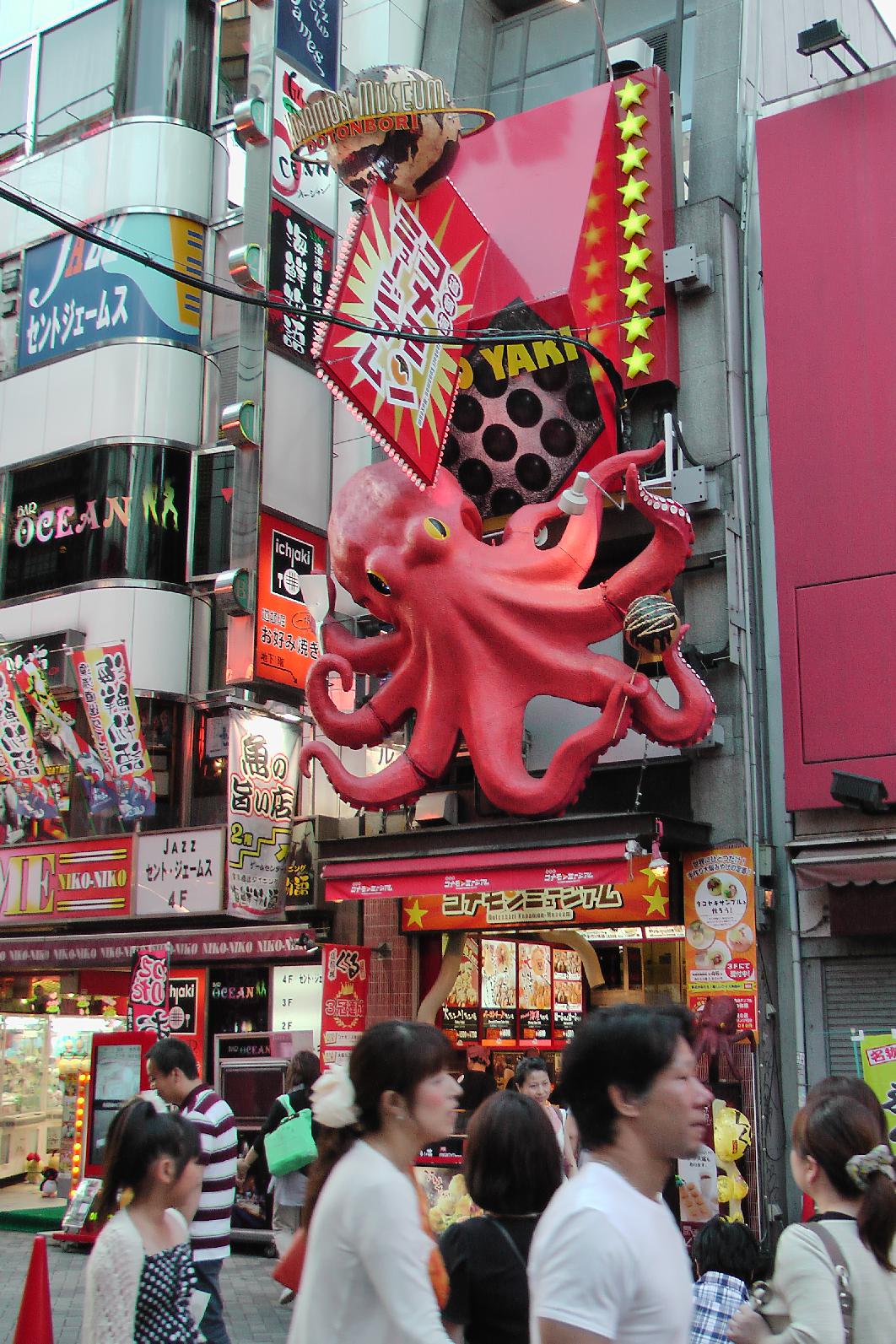 Restaurants with crazy/mad promotion methods close to the Dōtonbori canal.